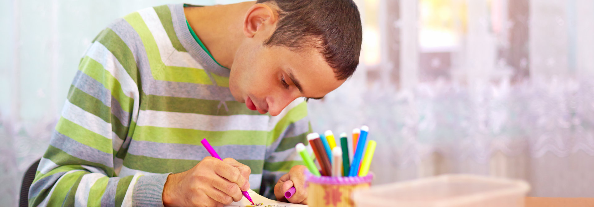 young man writing on notebook